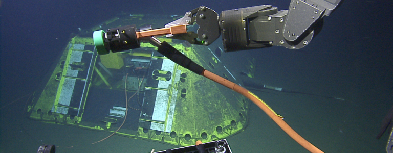 plugging in cable into underwater observatory